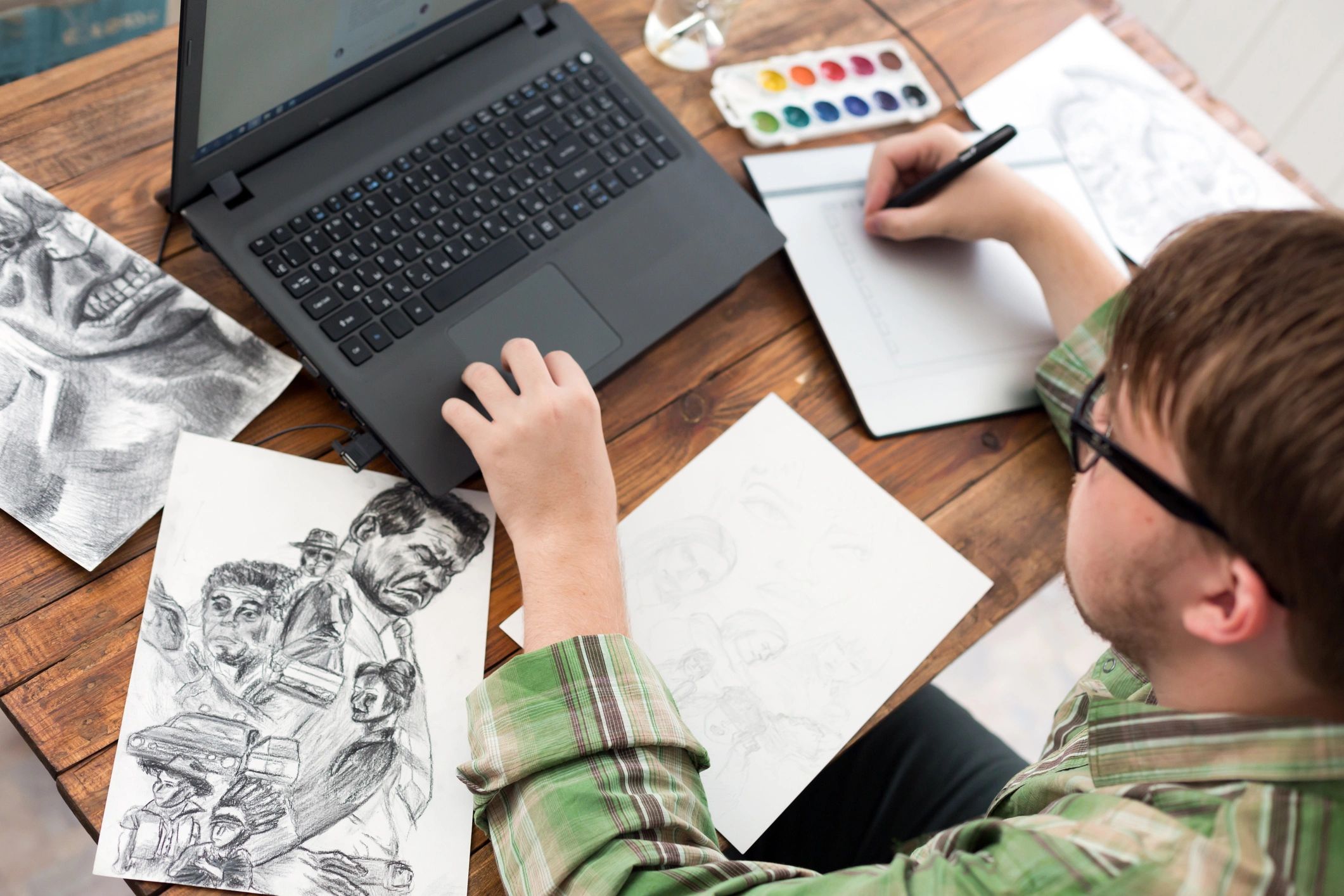 Young Man designer occupation drawing sketch using paper